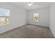 Bedroom with neutral walls, carpeted floor, natural light from two windows, and ceiling fan at 316 Barley Mill Rd, Holly Springs, NC 27540
