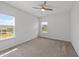 Minimal bedroom with large windows, ceiling fan, and neutral carpet for a calming atmosphere at 316 Barley Mill Rd, Holly Springs, NC 27540