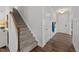 Warm and welcoming entryway with hardwood floors and a staircase to the upper level at 316 Barley Mill Rd, Holly Springs, NC 27540