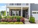 Inviting entryway with a stylish front door, stone accents, and well-manicured landscaping at 316 Barley Mill Rd, Holly Springs, NC 27540