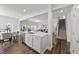 Open-concept kitchen with island, stainless steel sink, and seating flowing into dining and living areas at 316 Barley Mill Rd, Holly Springs, NC 27540
