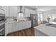 Modern kitchen features white cabinetry, stainless steel appliances, and a stylish backsplash at 316 Barley Mill Rd, Holly Springs, NC 27540