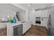 Bright kitchen boasts an island with a sink, modern appliances, and wood floors at 316 Barley Mill Rd, Holly Springs, NC 27540