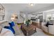 Open-concept living room with hardwood floors, recessed lighting, and seamless flow to the kitchen at 316 Barley Mill Rd, Holly Springs, NC 27540