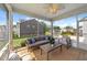 Cozy screened-in patio with comfortable seating and view of the backyard fire pit at 316 Barley Mill Rd, Holly Springs, NC 27540