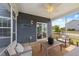 Relaxing screened-in patio with stylish furnishings, fan, and string lights at 316 Barley Mill Rd, Holly Springs, NC 27540