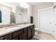 Bathroom with double sinks, granite countertops, dark wood cabinets and tile floors at 3248 Castlerock Dr, Burlington, NC 27215