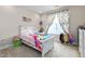 Bedroom with white bed, bright bedding, curtains, and natural light at 3248 Castlerock Dr, Burlington, NC 27215