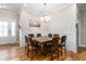 A well-lit dining room with hardwood floors, crown molding, and an elegant chandelier at 3248 Castlerock Dr, Burlington, NC 27215