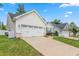 View of the house with a two-car garage, long driveway and well-maintained greenery at 3248 Castlerock Dr, Burlington, NC 27215