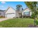 Charming single-Gathering home featuring a two-car garage, manicured lawn, and welcoming curb appeal at 3248 Castlerock Dr, Burlington, NC 27215