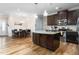 Open-concept kitchen and dining area featuring an island, modern lighting, and stylish finishes at 3248 Castlerock Dr, Burlington, NC 27215