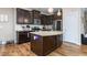 Kitchen featuring granite countertops, stainless steel appliances, a center island, and dark wood cabinets at 3248 Castlerock Dr, Burlington, NC 27215