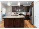 Modern kitchen with a center island, stainless steel appliances, and dark wood cabinetry at 3248 Castlerock Dr, Burlington, NC 27215