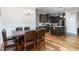 Open-concept space with a dining area leading into a modern kitchen with dark wood cabinets at 3248 Castlerock Dr, Burlington, NC 27215