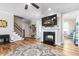Living room with a fireplace, hardwood floors, ceiling fan, and staircase leading to the upper level at 3248 Castlerock Dr, Burlington, NC 27215