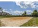 Sandy community volleyball court with lush landscaping and a view of nearby homes at 3248 Castlerock Dr, Burlington, NC 27215