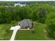 Stunning aerial view of a home with beautiful landscaping and a lake in the distance at 325 Forest Bridge Rd, Youngsville, NC 27596