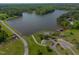 Aerial view of a lakefront property with a private dock and a bridge to the mainland at 325 Forest Bridge Rd, Youngsville, NC 27596