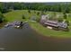Expansive aerial view showcases lakeside community amenities, featuring docks and lush green spaces at 325 Forest Bridge Rd, Youngsville, NC 27596