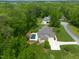 Gorgeous aerial view of a home with a sparkling pool nestled among lush trees and green lawns at 325 Forest Bridge Rd, Youngsville, NC 27596