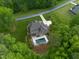 An aerial shot exhibits a home with a pool and extensive outdoor space, surrounded by trees and manicured lawns at 325 Forest Bridge Rd, Youngsville, NC 27596