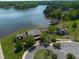 Aerial shot of lakefront property with dock, lush landscaping, and multiple buildings at 325 Forest Bridge Rd, Youngsville, NC 27596