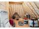 Unfinished attic featuring exposed beams with spray foam insulation and items being stored at 325 Forest Bridge Rd, Youngsville, NC 27596