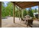 Outdoor living area includes a grill and patio dining set overlooking the pool at 325 Forest Bridge Rd, Youngsville, NC 27596