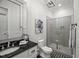 Modern bathroom features a glass shower, black granite vanity, and decorative touches at 325 Forest Bridge Rd, Youngsville, NC 27596
