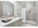 Bathroom featuring a shower, vanity with mirror, and white marble countertops at 325 Forest Bridge Rd, Youngsville, NC 27596