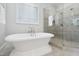 Relaxing bathroom featuring a soaking tub and glass enclosed shower at 325 Forest Bridge Rd, Youngsville, NC 27596