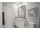 Charming bathroom with granite vanity, decorative mirror, and neutral color scheme at 325 Forest Bridge Rd, Youngsville, NC 27596