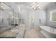 Elegant bathroom boasts dual sinks, granite countertops, and a luxurious chandelier at 325 Forest Bridge Rd, Youngsville, NC 27596