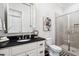 Modern bathroom with dark vanity and seamless glass shower at 325 Forest Bridge Rd, Youngsville, NC 27596