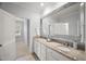 Elegant bathroom features dual sinks, granite vanity, and large decorative mirror at 325 Forest Bridge Rd, Youngsville, NC 27596