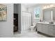 Elegant bathroom showcasing a modern vanity with a framed mirror, tile flooring, and a shower-tub combo at 325 Forest Bridge Rd, Youngsville, NC 27596