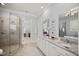 Bright bathroom features a glass-enclosed shower, dual vanities, and stylish mirrors at 325 Forest Bridge Rd, Youngsville, NC 27596