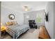 Comfortable bedroom with ceiling fan, plaid bedding, and a dedicated computer gaming area at 325 Forest Bridge Rd, Youngsville, NC 27596