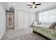 Cozy bedroom featuring soft carpet, crown molding, a ceiling fan, and a comfortable chair near the window at 325 Forest Bridge Rd, Youngsville, NC 27596