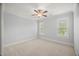 This spacious bedroom features neutral carpeting, two large windows, and a ceiling fan at 325 Forest Bridge Rd, Youngsville, NC 27596
