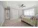 Comfortable bedroom featuring neutral carpeting, a ceiling fan, and a cozy armchair at 325 Forest Bridge Rd, Youngsville, NC 27596