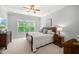 Well-lit bedroom featuring a large window and classic wooden furniture at 325 Forest Bridge Rd, Youngsville, NC 27596