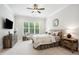 Bright bedroom featuring neutral decor, a ceiling fan, and a large window at 325 Forest Bridge Rd, Youngsville, NC 27596