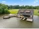 Picturesque boathouse on the water with a sun deck and dock for easy lake access at 325 Forest Bridge Rd, Youngsville, NC 27596
