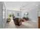 Bright bonus room with large window, ceiling fan, and comfortable seating area at 325 Forest Bridge Rd, Youngsville, NC 27596