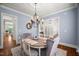 Light and airy dining room featuring hardwood floors, chandelier lighting, and stylish furnishings at 325 Forest Bridge Rd, Youngsville, NC 27596