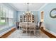 Elegant dining room featuring modern lighting, soft blue walls, and decorative accents at 325 Forest Bridge Rd, Youngsville, NC 27596