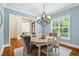 Elegant dining room featuring modern lighting, soft blue walls, and decorative accents at 325 Forest Bridge Rd, Youngsville, NC 27596