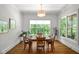 Sunlit dining room with hardwood floors, large windows, and a cozy atmosphere at 325 Forest Bridge Rd, Youngsville, NC 27596